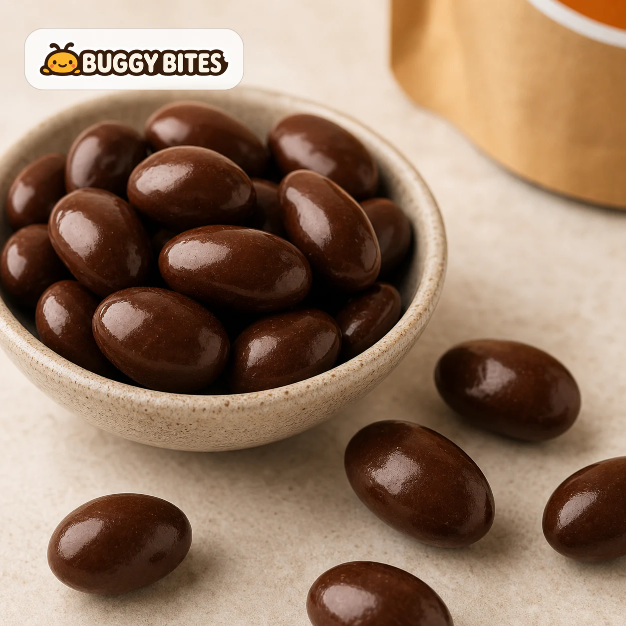 Close-up of Buggy Bites chocolate cricket snack pieces with the real shop logo